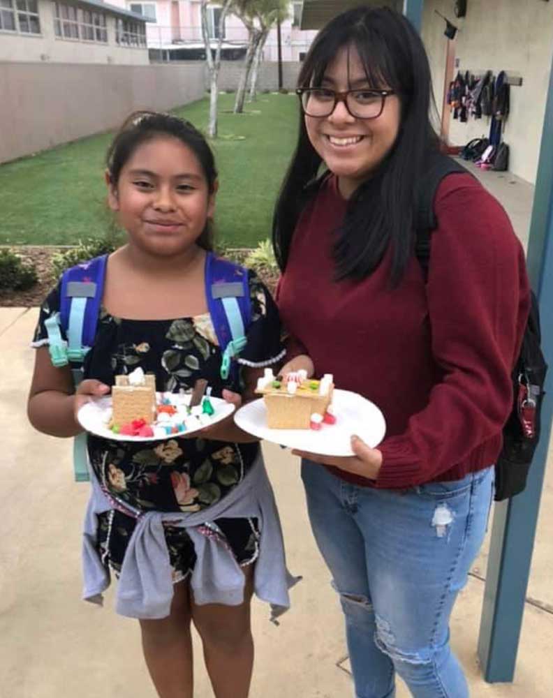 High school volunteer Esmeralda with her mentee Gladis