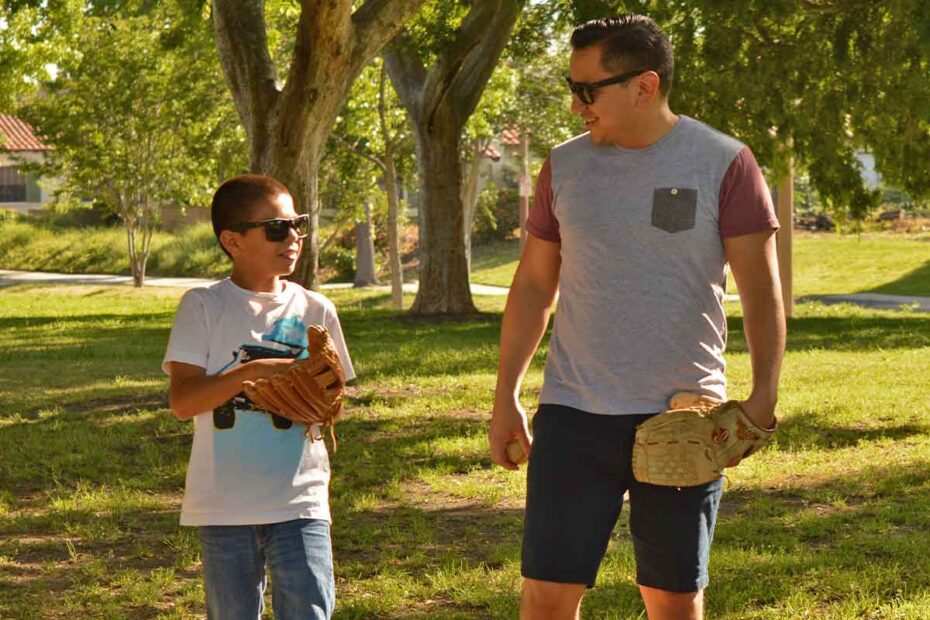 A male volunteer in Orange County plays catch with his mentee.