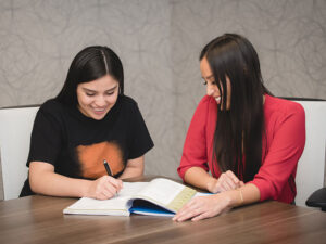 A corporate employee mentors a high school student at her workplace